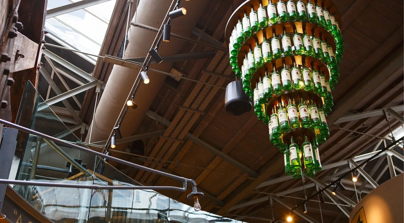 A chandelier of Jameson whiskey bottles in the Bow St. Distillery atrium