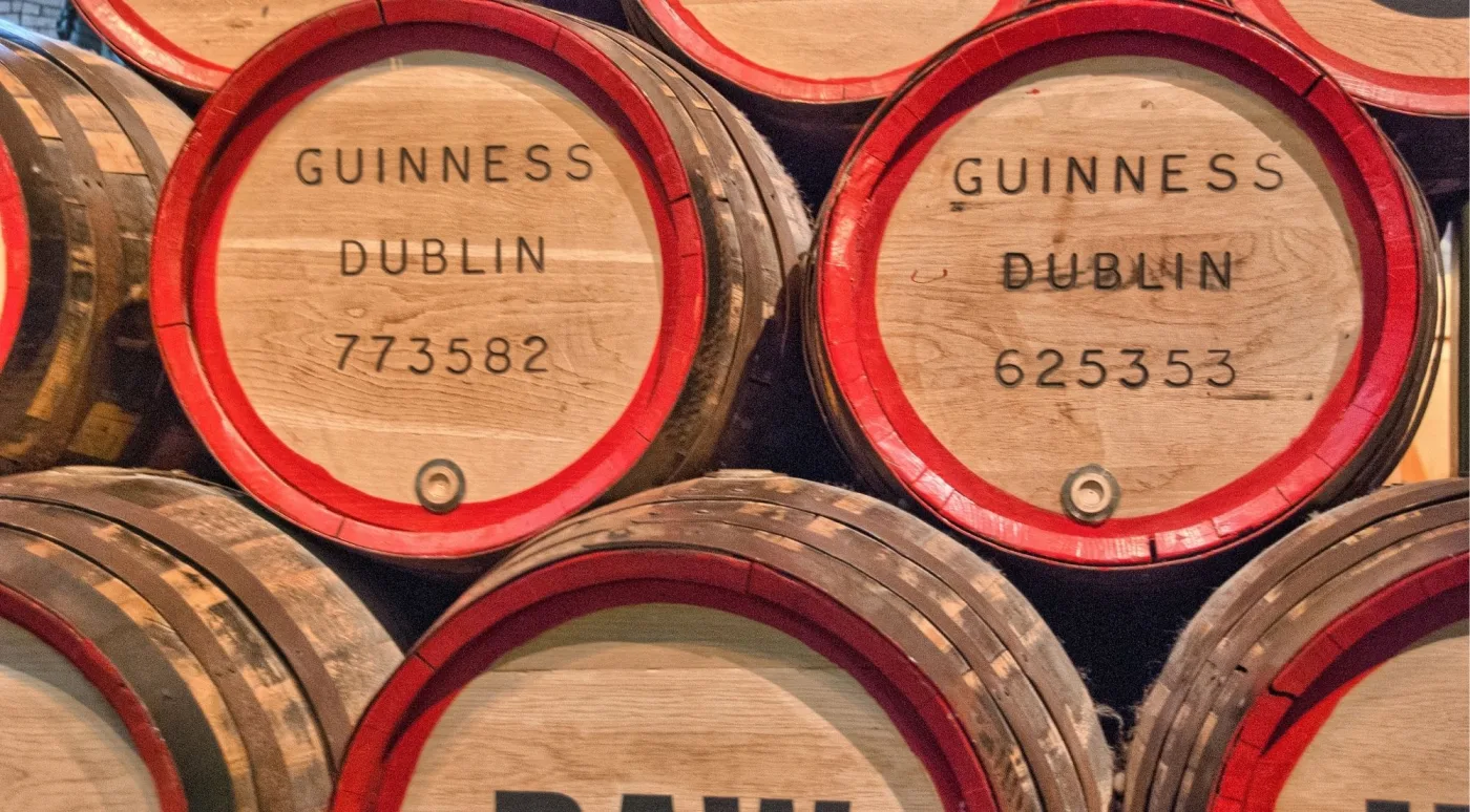 Oak casks branded 'Guinness Dublin' stacked for barrel-ageing whiskey