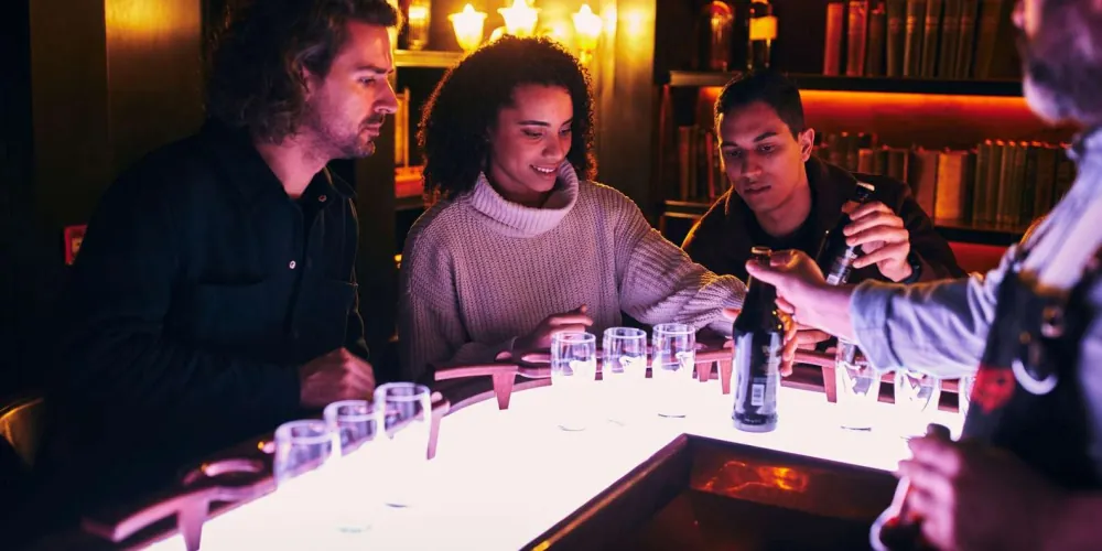 An illuminated tasting table set with Guinness sampling glasses