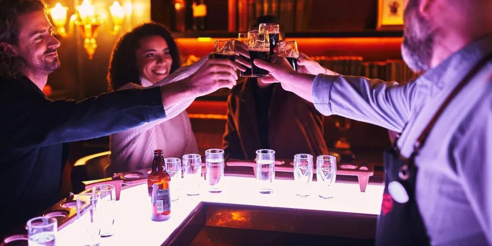 Friends raising a toast with pints during a Guinness tasting